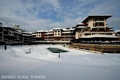 a snow covered parking lot in front of a building at Bansko Royal Towers - Studio 815 in Bansko