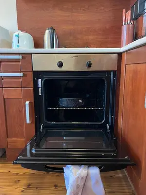 an oven with its door open in a kitchen at Vesta Boutique Apartment in Bansko