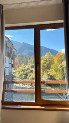 a window with a view of a mountain view at Vesta Boutique Apartment in Bansko
