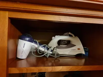 a hair dryer and a blow dryer sitting on a shelf at Vesta Boutique Apartment in Bansko