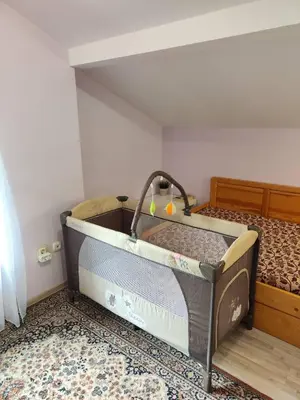 a small bed in a room with a bed sqor at Еко вила Дивна - Тетевенски балкан in Divchovoto