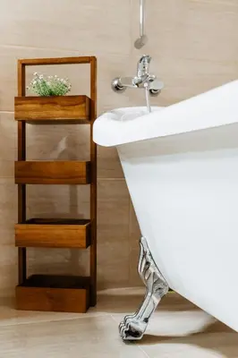 a bathroom with a sink and a plant on a shelf at Семеен хотел и ресторант Райски залив in Golyama Zhelyazna