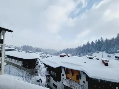 a snow covered roof of a building with snow covered roofs at Гранд Манастира Пампорово, Двустаен апартамент Deluxe in Pamporovo