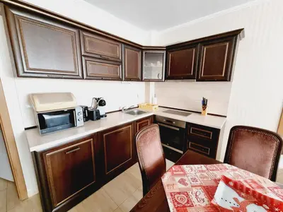 a small kitchen with a table and a microwave at Гранд Манастира Пампорово, Двустаен апартамент Deluxe in Pamporovo