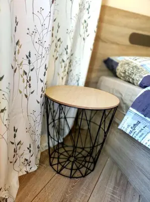 a round table in a room with a couch and a curtain at vins studio in Bansko