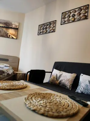 a room with a table and a couch with pillows at vins studio in Bansko