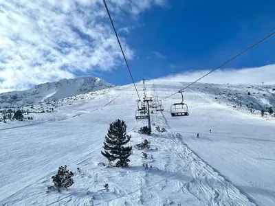 a ski lift on top of a snowy mountain at Ground floor 2-bedrooms, 2-bathrooms apartment near Bansko in a complex with pools and SPA included in Razlog