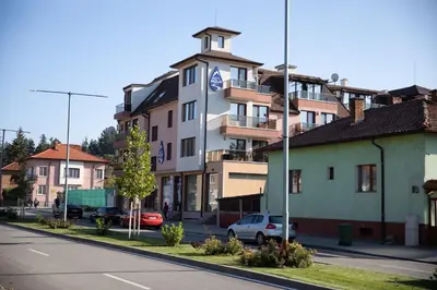 a building on the side of a city street at Баня Аква Ризорт in Banya