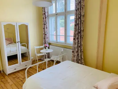a bedroom with a bed and a window and a table at TÁNIN HOUSE - Three-bedroom apartment, sauna and gym 10' away from Borovets in Samokov
