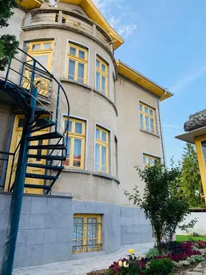 a building with a spiral staircase on the side of it at TÁNIN HOUSE - Three-bedroom apartment, sauna and gym 10' away from Borovets in Samokov