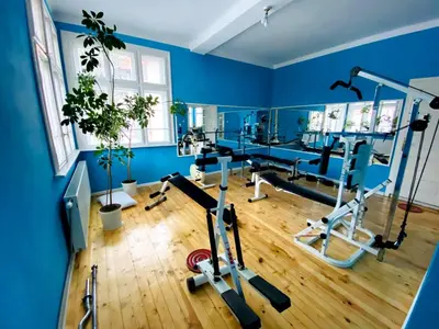 a gym with blue walls and tread machines at TÁNIN HOUSE - Three-bedroom apartment, sauna and gym 10' away from Borovets in Samokov