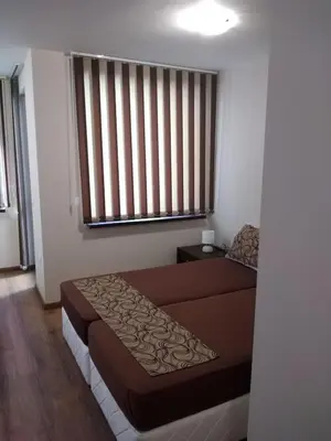 a bedroom with a brown bed and a window at Borovets Gardens apartment A20 in Borovets