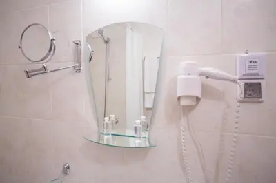 a shower with a mirror in a bathroom at Bright Studio in a Spacious Complex in the Valley by Flat Mаnager in Bansko
