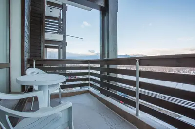 a table and chairs on a balcony with a view at Bright Studio in a Spacious Complex in the Valley by Flat Mаnager in Bansko