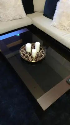 a coffee table with three candles on top of it at Neviasta Apartment in Smolyan