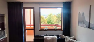 a living room with a window with a view at Neviasta Apartment in Smolyan