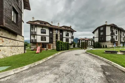 an empty street with two large houses on the side at Cozy One-Bedroom apartment with Nature View by Flat Mаnager in Razlog