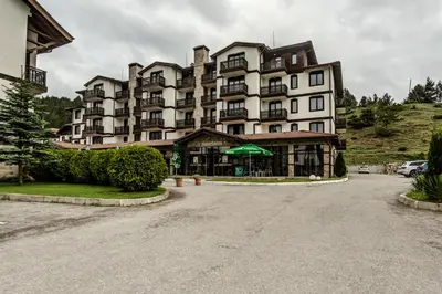 a large apartment building with a parking lot in front of it at Cozy One-Bedroom apartment with Nature View by Flat Mаnager in Razlog