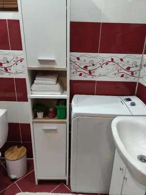 a small bathroom with a sink and a white refrigerator at Bansko Dream Apartment City Center in Bansko