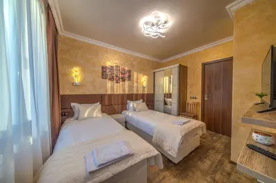 a hotel room with two beds and a mirror at Forest Home 524 in Smolyan