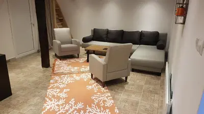 a living room with a couch and a chair at Algarte Guest House in Madzhare