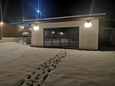 a building with a lot of snow in front of it at Algarte Guest House in Madzhare