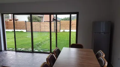 a conference room with a table and chairs and a large window at Algarte Guest House in Madzhare