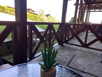 a plant sitting on a glass table on a balcony at Студио Snow day в Green life в Банско in Bansko
