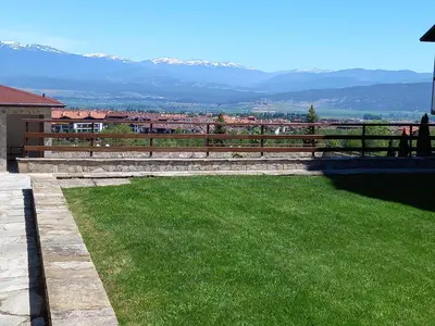 a yard with a fence and a green lawn at Студио Snow day в Green life в Банско in Bansko