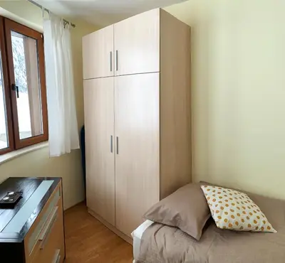 a bedroom with a bed and a desk and a cabinet at Ski Area 202 apt, The Castle 1, Pamporovo in Pamporovo
