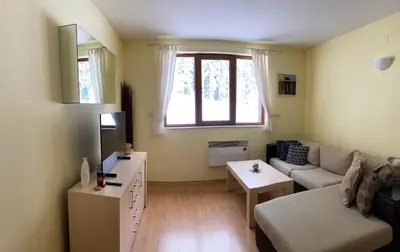 a living room with a couch and a table at Ski Area 202 apt, The Castle 1, Pamporovo in Pamporovo