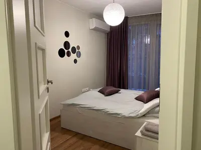 a small bedroom with a bed and a window at Уютен апартамент на 3 мин. от главната и Капана +паркинг in Plovdiv