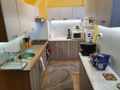 a small kitchen with a sink and a microwave at Koko's apartments 2 in Bansko