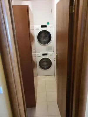 a bathroom with a washing machine and a washer and dryer at Koko's apartments 2 in Bansko