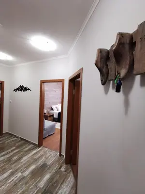 a hallway with a room with a bed and a room with at Cedar 42 in Bansko