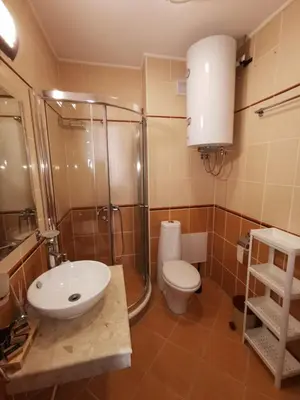 a bathroom with a sink and a shower and a toilet at Cedar 42 in Bansko