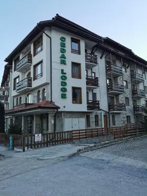 a building with a sign on the side of it at Cedar 42 in Bansko