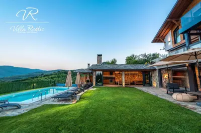 a house with a swimming pool and a yard at Вила Рустик / Villa Rustic in Kyustendil