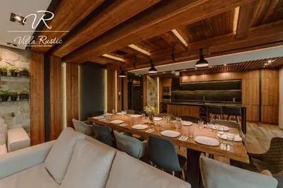 a dining room with a long table and a couch at Вила Рустик / Villa Rustic in Kyustendil