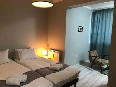 a bedroom with a bed with two towels on it at EU metro station, City Center, lovely 3-bedroom apartment, free parking in Sofia