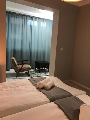 a bedroom with a bed with two towels on it at EU metro station, City Center, lovely 3-bedroom apartment, free parking in Sofia