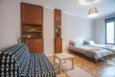a living room with a couch and a table at Sofia center, Shishman street bijou in Sofia