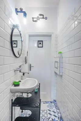 a white bathroom with a sink and a mirror at Sofia center, Shishman street bijou in Sofia
