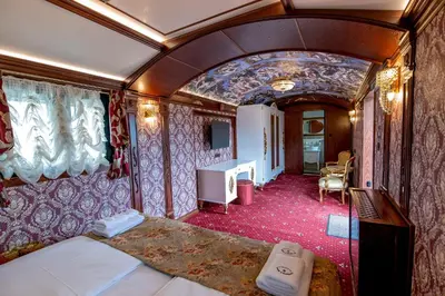 a room with a bed in a train car at Camping Alliance in Plovdiv
