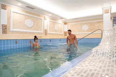 a man and a child in a swimming pool at Camping Alliance in Plovdiv