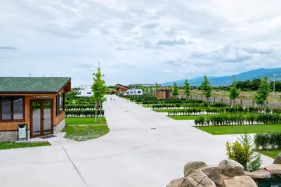a walkway leading to a building with a garden at Camping Alliance in Plovdiv