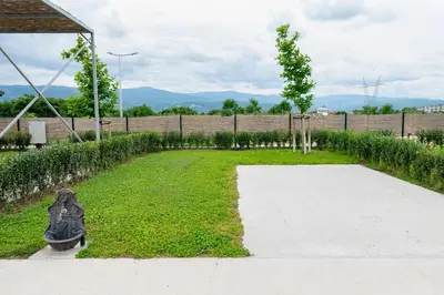a garden with a statue in the grass at Camping Alliance in Plovdiv
