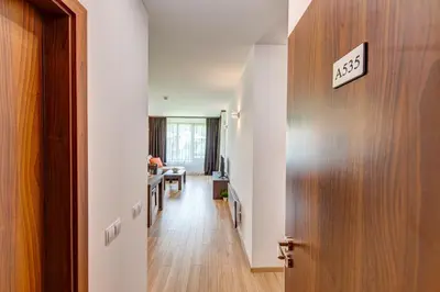 a hallway with a door with a sign on it at 4 Seasons Apartment 535, Oak Residence in Smolyan