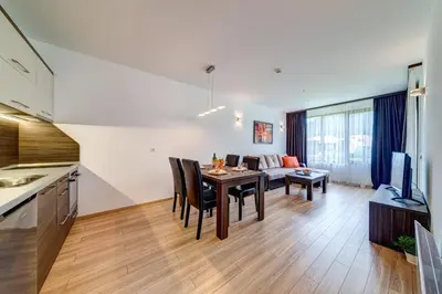 a kitchen and living room with a table and a couch at 4 Seasons Apartment 535, Oak Residence in Smolyan