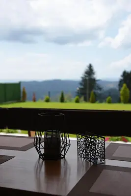 two black baskets sitting on a table with a view of a golf course at Вила Релакс in Pamporovo